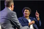  ??  ?? Democratic candidate Stacey Abrams, speaking with Georgia Chamber of Commerce CEO Chris Clark, cited working with a GOP governor on the HOPE scholarshi­p overhaul as an example of her bipartisan approach.