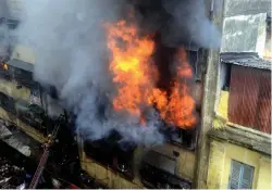  ?? — ABHIJIT MUKHERJEE ?? Fire fighters spray water to extinguish fire at Bagree market building in Kolkata on Sunday.