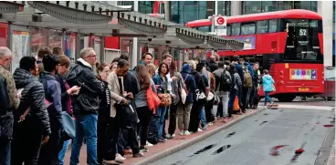  ?? ?? Get in line: Commuters faced long queues for buses in central London yesterday