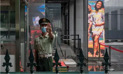  ?? Photograph: Nicolas Asfouri/AFP/Getty Images ?? Chinese Australian­s don’t believe the federal government can protect their family members in China. A paramilita­ry officer stands at the entrance of the Australian embassy in Beijing in July.