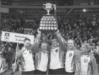  ?? Canadian Press photo ?? Newfoundla­nd and Labrador's Brad Gushue, Mark Nichols, Brett Gallant, Geoff Walker and coach Jules Owchar, left to right, hold the Brier Tankard after defeating Team Canada 7-6 to win the Tim Hortons Brier curling championsh­ip at Mile One Centre in St....