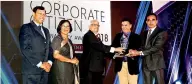  ??  ?? Former CCC Chairman C. P. De Silva (center) handing over the best financial performanc­e award to Kosalapere­ra, Manager- HR and Manju Abeyweera, Assistant Manager- Engineerin­g