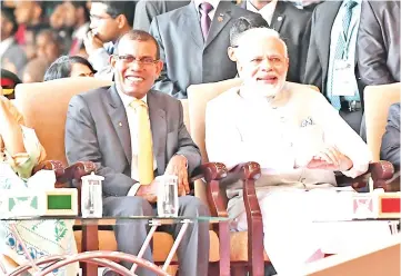  ??  ?? This handout photograph shows Modi (right) seated with former Maldives president Mohamed Nasheed (left), who recently returned from exile, during the inaugurati­on of new Maldives President Ibrahim Mohamed Solih in Male. — AFP photo