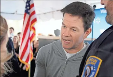  ?? Daniel Bell ?? Actor Mark Wahlberg speaks to Kathy Johnson, president and CEO of the Gordon County Chamber of Commerce, before the start of a ribbon-cutting event at the Walmart Health Center in Calhoun on Wednesday.