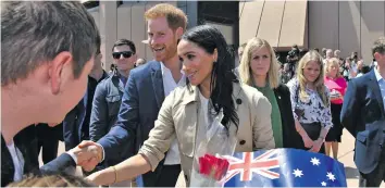  ?? Photo: AAP ?? Thousands of fans lined up for a glimpse of Prince Harry and Meghan Markle outside the Sydney Opera House in Australia on October 16, 2018.