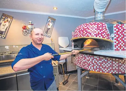  ??  ?? The Lovat Hotel’s new 150-seat family restaurant Manhattans includes a large pizza oven, being demonstrat­ed by pizza chef Pietir Mai. Picture: Steve MacDougall.