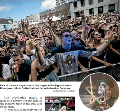  ?? ROBERT KITCHIN/STUFF ?? Fans at the rock stage – one of five stages at Wellington’s annual Homegrown Music festival held on the waterfront on Saturday. Former Blindspott drummer Shelton Woolright performs with Deadbeat.