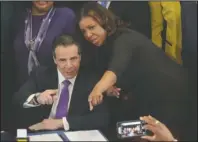  ?? The Associated Press ?? ADVOCATE AND GOVERNOR: In this April 26, 2018, file photo, then-New York Public Advocate Letitia James, right, speaks with New York Gov. Andrew Cuomo, center, at an event in New York. President Donald Trump lashed out at New York’s governor and attorney general Monday, accusing the Democrats of going after him in a “political Witch Hunt.” In four tweets, Trump accused Gov. Andrew Cuomo and Attorney General Letitia James of “harassing all of my New York businesses in search of anything at all they can find to make me look as bad as possible.”
