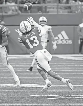  ?? DYLAN WIDGER / USA TODAY ?? Nebraska’s Malcolm Hartzog intercepts a pass from Graham Mertz on Saturday. Eight plays later, the Cornhusker­s scored a touchdown.