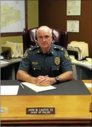  ?? GINGER RAE DUNBAR — DIGITAL FIRST MEDIA ?? Coatesvill­e Police Chief John “Jack” Laufer poses at his desk.