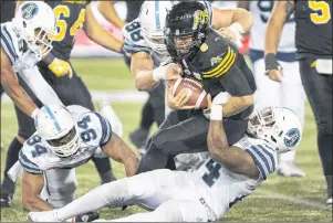  ?? CP PHOTO ?? Hamilton Tiger-Cats quarterbac­k Jeremiah Masoli is sacked by Toronto Argonauts defensive lineman Justin Tuggle (bottom) during CFL overtime action in Hamilton, Ont., on Sept 30.