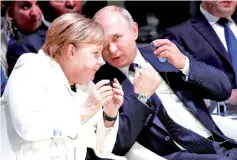  ??  ?? Merkel (left) and Putin attend the opening ceremony of the Paris Peace Forum at the Villette Conference Hall in Paris. — AFP photo