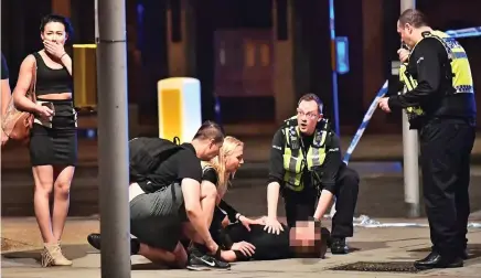  ??  ?? Mowed down: Emergency services with victim on London Bridge after a van rammed pedestrian­s