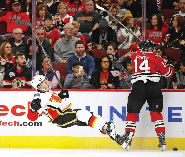  ?? JONATHAN DANIEL/GETTY IMAGES ?? Travis Hamonic took an elbow to the nose courtesy of Chris Kunitz during Sunday’s game in Chicago, but came back to help Calgary collect a 3-2 win.