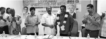  ??  ?? Jothi (left) and Mohan with MIC Kota Kinabalu leaders at the AGM yesterday.