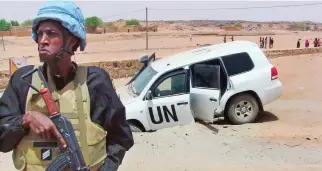  ??  ?? A soldier from the UN peacekeepi­ng mission in Mali stands guard near a vehicle after it drove over an explosive device near Kidal in this file photo. (AFP)