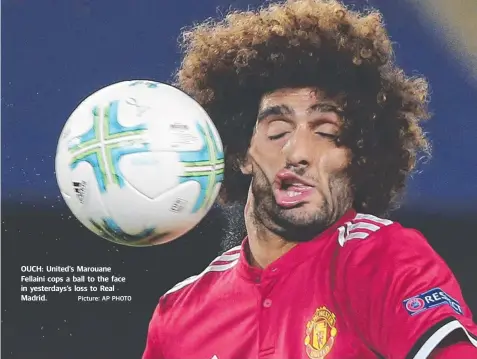  ?? Picture: AP PHOTO ?? OUCH: United's Marouane Fellaini cops a ball to the face in yesterdays’s loss to Real Madrid.