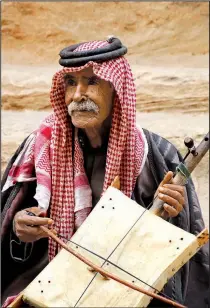  ??  ?? A Bedouin musician plays a rababa, a traditiona­l instrument that is an Arab fiddle.