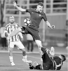  ??  ?? Roma’s Edin Dzeko (centre) vies with Pescara goalkeeper Vincenzo Fiorillo during the Italian Serie A match at the Adriatico Stadium in Pescara, in this April 24 file photo. — AFP photo