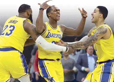  ?? AP ?? Los Angeles Lakers guard Rajon Rondo, (middle) celebrates his game-winning shot with teammates LeBron James and Kyle Kuzma, in their game against the Boston Celtics in Boston.