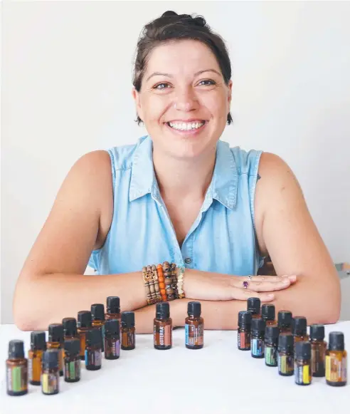  ?? Picture: JUSTIN BRIERTY ?? NATURAL CHOICE: Wellness advocate Courtney Pitcher from the Moreton Bay Hippy with some of the essential oils she uses as insect repellent and remedies for various ailments.