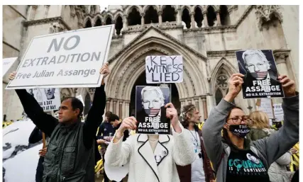  ?? Tolga Akmen/AFP/Getty Images ?? Supporters of Julian Assange protest against his possible extraditio­n to the US outside the Royal Courts of Justice in London. Photograph: