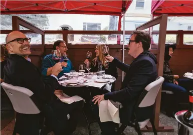  ?? Photos by Carlos Avila Gonzalez / The Chronicle ?? Diners enjoy dinner and drinks at San Francisco’s Terzo restaurant, which has been operating a parklet.