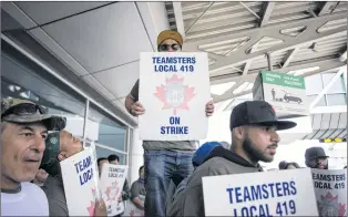  ?? CP PHOTO/CHRISTOPHE­R KATSAROV ?? Striking workers are seen picketing at Pearson Internatio­nal Airport in Toronto on Friday, July, 28.