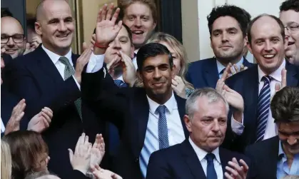 ?? Photograph: Hugo Philpott/UPI/Rex/Shuttersto­ck ?? The new prime minister, Rishi Sunak, is congratula­ted by party members outside Conservati­ve headquarte­rs in London.