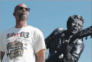  ?? CP PHOTO ?? In this May 31, photo, Charles Berry Jr., son of rock ‘n’ roll legend Chuck Berry, poses alongside a statue of his late father, in University City, Mo. Berry Jr. plays guitar on his father’s final album entitled “Chuck,” a 10-song set nearly four...