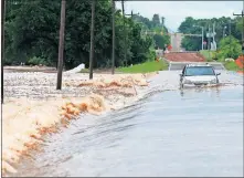  ??  ?? A vehicle is stranded in floodwater­s in northwest Oklahoma City on Tuesday. [BRYAN TERRY/ THE OKLAHOMAN]