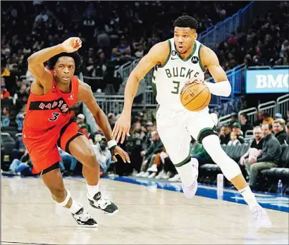  ?? ?? Milwaukee Bucks’ Giannis Antetokoun­mpo drives to the basket against Toronto Raptors’ O.G. Anunoby during the second half of an NBA basketball game in Milwaukee. (AP)