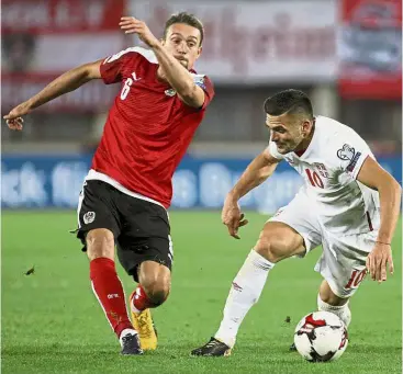  ?? — AP ?? That’s mine: Austria’s Stefan Ilsanker (left) vying for the ball with Serbia’s Dusan Tadic during the World Cup Group D qualifier at the Ernst Happel Stadium in Vienna, Austria, on Friday.