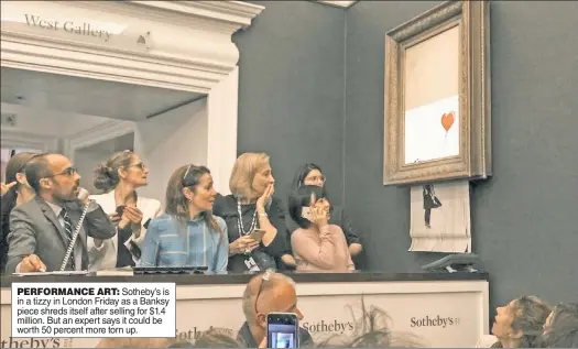  ??  ?? PERFORMANC­E ART: Sotheby’s is in a tizzy in London Friday as a Banksy piece shreds itself after selling for $1.4 million. But an expert says it could be worth 50 percent more torn up.