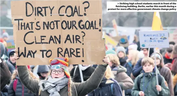  ??  ?? &gt; Striking high school students march in front of the Reichstag building, Berlin, earlier this month during a protest for more effective government climate change policy