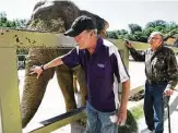  ?? Bob Owen / Staff file photo ?? Keith Hodges, left, and Raymond Figueroa are reunited with Lucky the elephant in 2016.