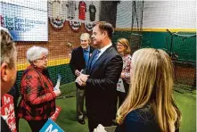  ?? Lea Suzuki/ The Chronicle ?? Former Mayor and Supervisor Mark Farrell, center, speaks with family and supporters Tuesday at a campaign launch event at the San Francisco Baseball Academy.