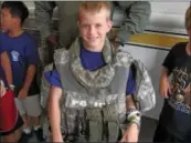  ??  ?? Upper Dublin Junior Police Academy camper Jeremy Grosche tries on a vest worn by SWAT
team members.