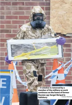  ?? Andrew Matthews ?? A window is removed by a member of the military as work continues on the home of former Russian spy Sergei Skripal in Salisbury