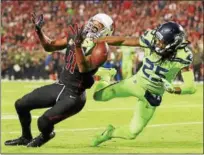  ?? PHOTO BY CHRISTIAN PETERSEN — GETTY IMAGES ?? Wide receiver Larry Fitzgerald #11of the Arizona Cardinals is unable to complete the pass against cornerback Richard Sherman #25of the Seattle Seahawks in the first half of the NFL game at University of Phoenix Stadium on in Glendale, Arizona.