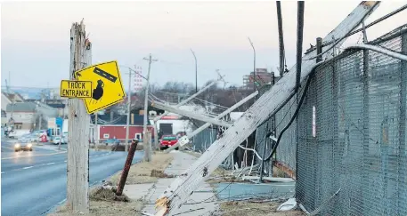  ?? ANDREW VAUGHAN, THE CANADIAN PRESS ?? Wicked winds on Monday downed this row of wooden utility poles in Dartmouth, N.S.