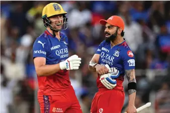  ?? AFP ?? Bengaluru’s Will Jacks and Virat Kohli celebrate their nine-wicket victory against Gujarat