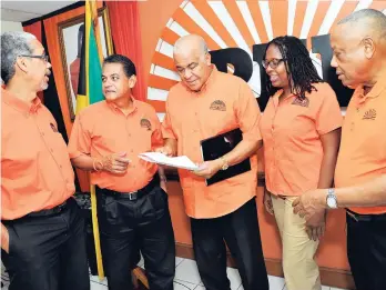  ??  ?? PNP Chairman Robert Pickersgil­l (centre), flanked by senior members of the party (from left), outgoing General Secretary Paul Burke, recently re-elected vice-presidents Noel Arscott, Angela Brown Burke and former vice-president Derrick Kellier.