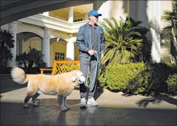  ?? John Locher The Associated Press ?? Kirk Herbstreit walks his dog Ben outside of his Las Vegas hotel the morning of the Raiders-chargers game at Allegiant Stadium.