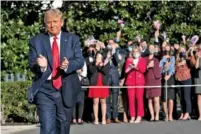  ?? AP PHOTO/ EVAN VUCCI ?? President Donald Trump walks over to talk with reporters Wednesday before boarding Marine One on the South Lawn of the White House in Washington.