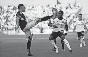  ?? ADAM CAIRNS/COLUMBUS DISPATCH ?? Crew forward Christian Ramirez kicks the ball over Pittsburgh Riverhound­s midfielder DZ Harmon on Wednesday.