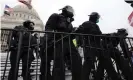  ?? Photograph: Spencer Platt/Getty Images ?? Law enforcemen­t position themselves as a pro-Trump mob gathers outside the US Capitol building on 6 January 2021.