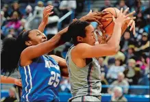  ?? SEAN D. ELLIOT/THE DAY ?? UConn’s Napheesa Collier, right, beats Memphis’ Brianna Porter to a rebound during Sunday’s game at the XL Center in Hartford.