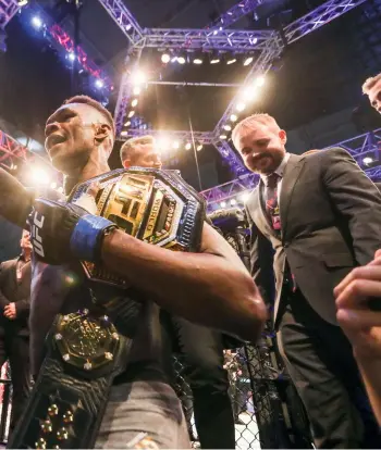  ??  ?? Above: Nigeria’s Israel Adesanya salutes the crowd in Las Vegas after successful­ly defending his middleweig­ht title at UFC 243 in October 2019.