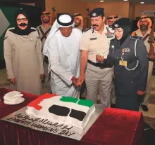  ?? Courtesy: Abu Dhabi Police ?? Major Dr Amnah Al Beloushi and other senior police officials cut a cake on the occasion of Emirati Women’s Day in Abu Dhabi.
